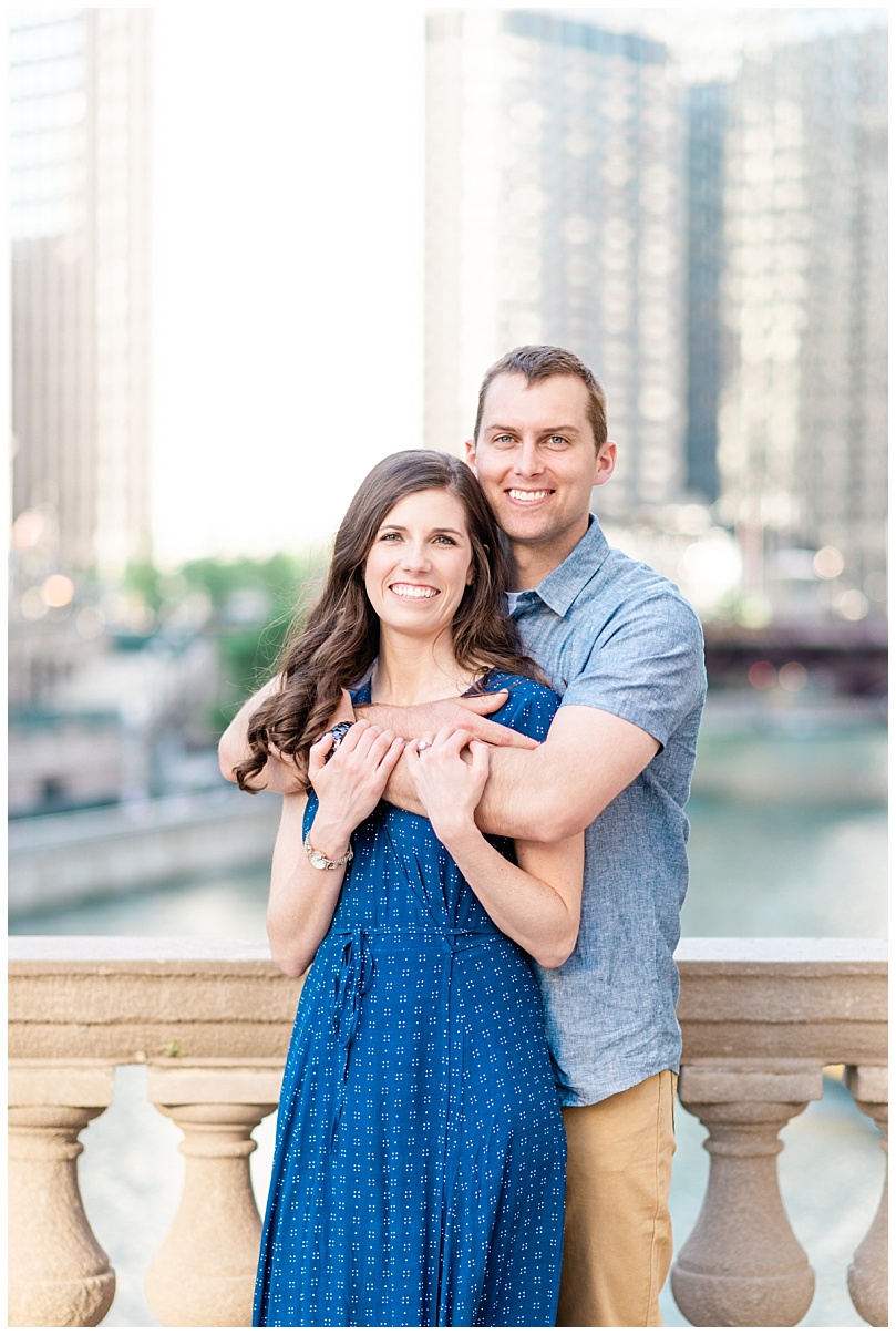 couple during their engagement session in front of the Wrigley Building