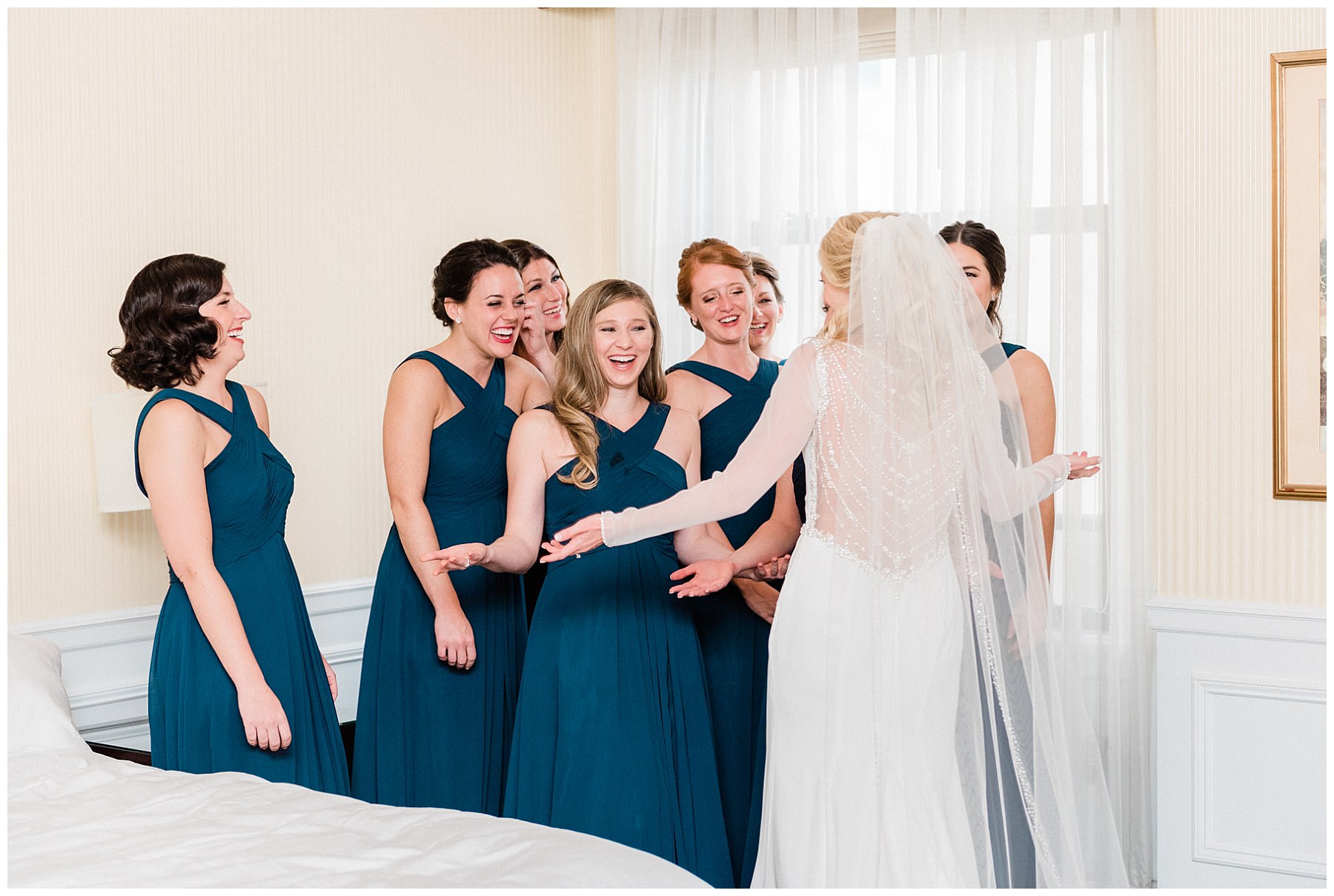 bride reveling herself to her bridesmaids on her wedding day at the drake hotel in chicago