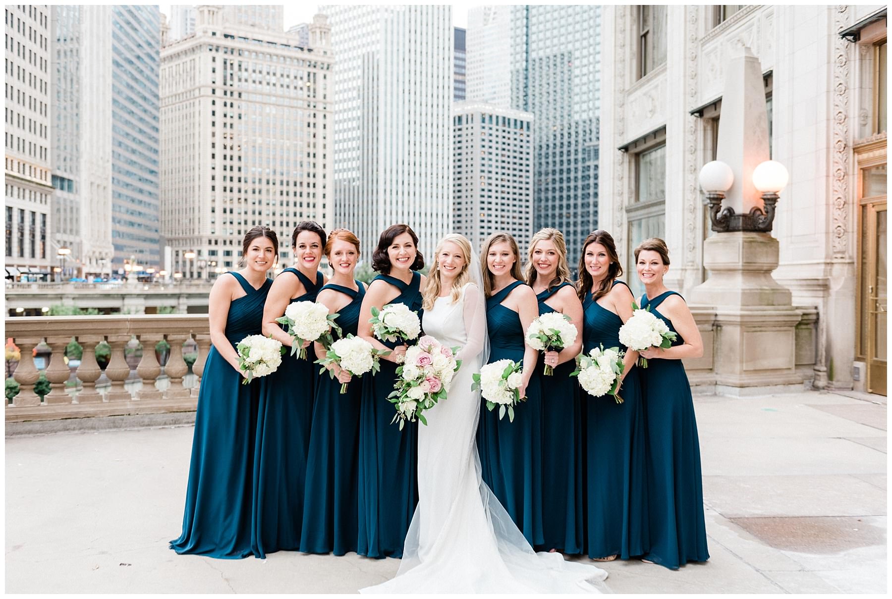 bride and bridesmaids photo by wrigley building in chicago