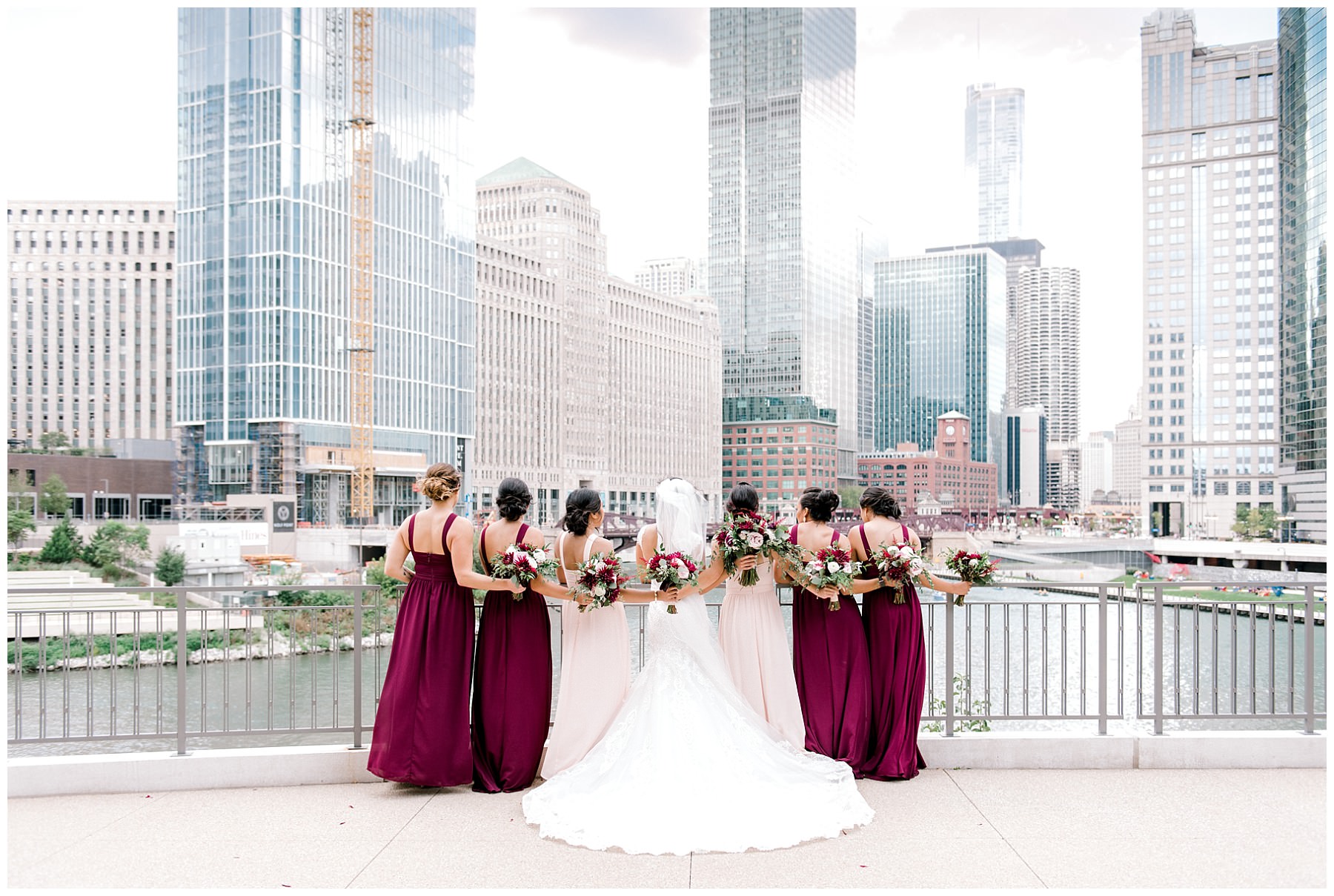 bride with bridesmaids turned away from the camera and looking at chicago river walk