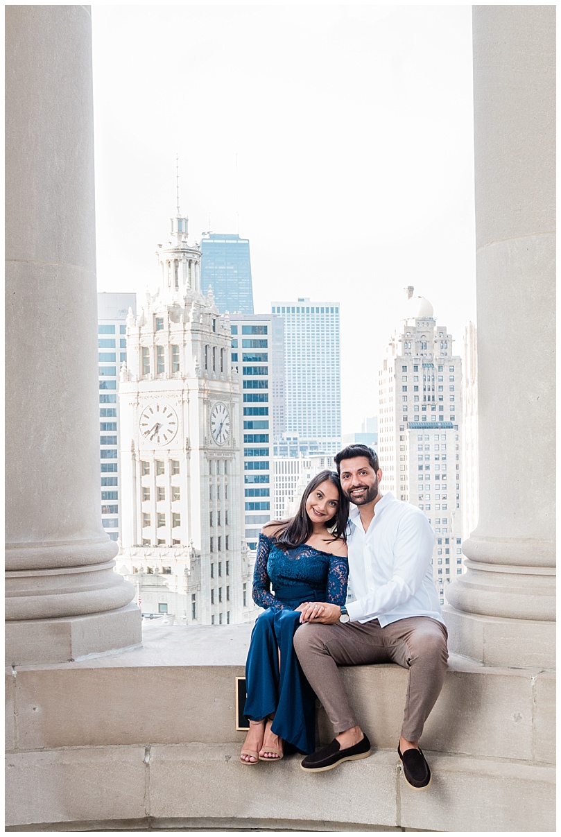 couple engaged at the london house cupola sitting on the edge