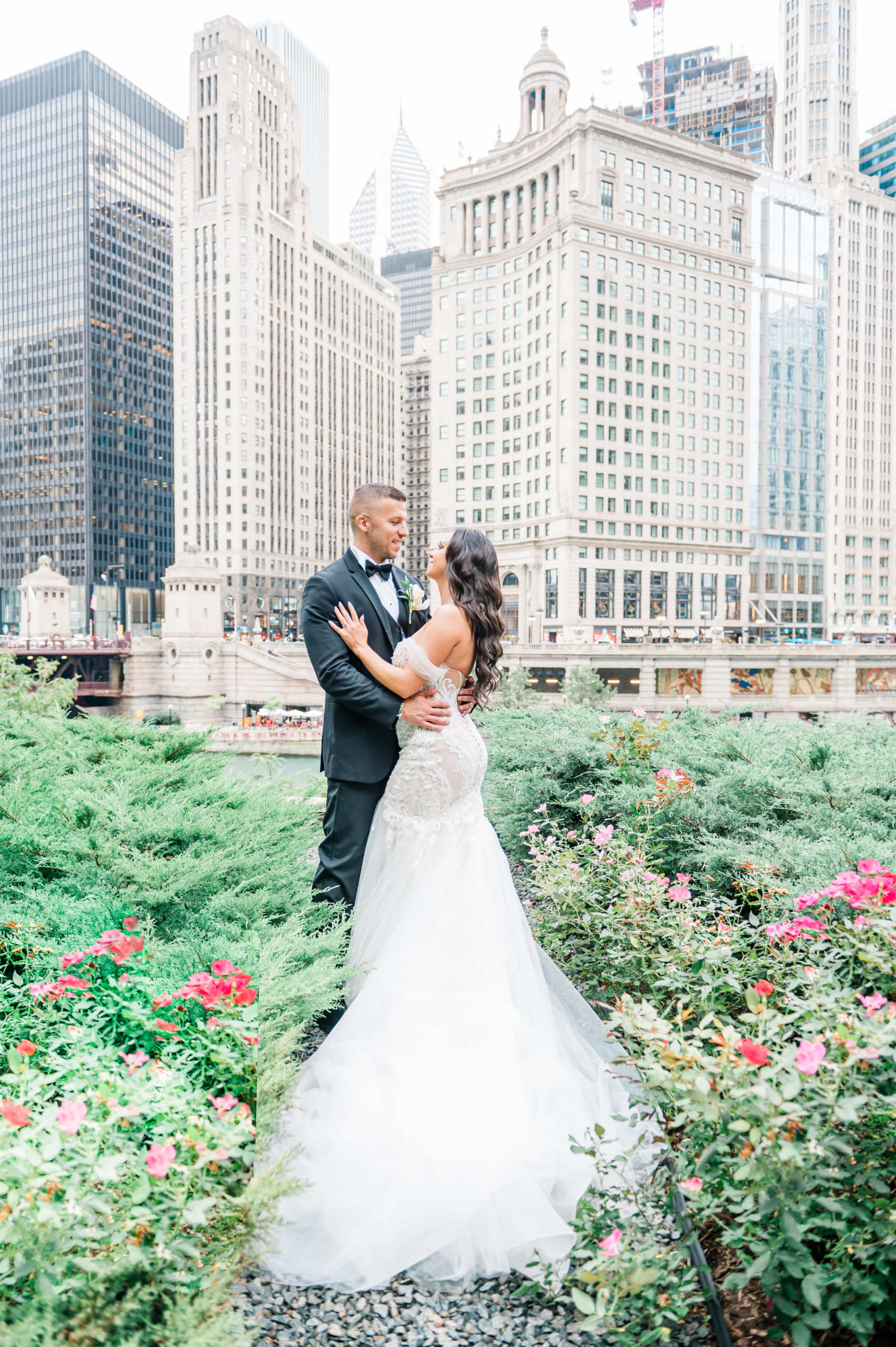 bride and groom taking their wedding photos at the wrigley building in Chicago